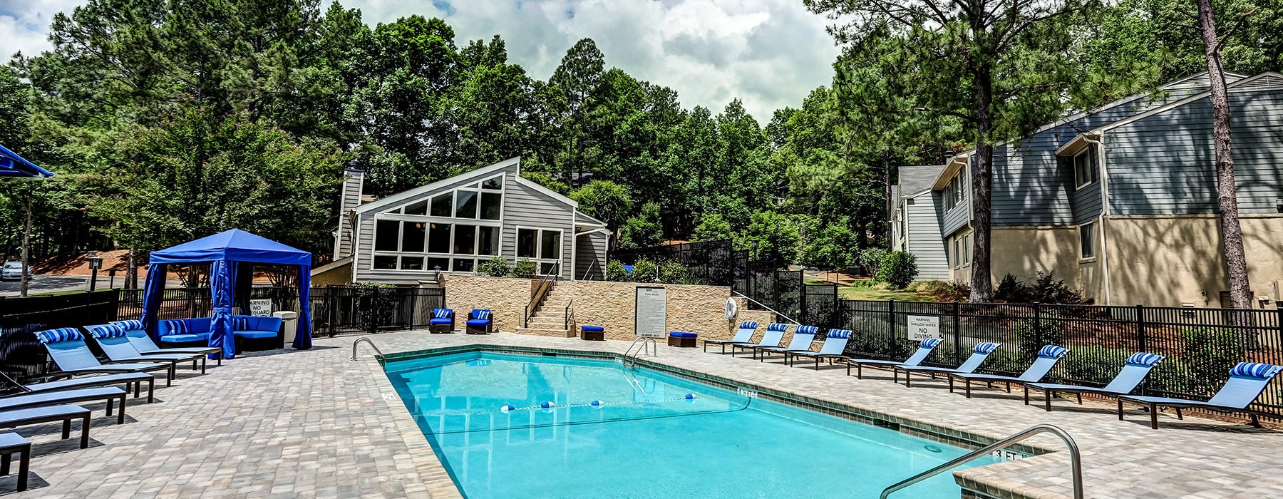 Poolside chaise lounge and cabana on sundeck at 700 Riverchase Apartments in Hoover, AL