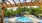 View of pool with resort-style chaise lounge chairs and cabana at 700 Riverchase Apartments in Hoover, AL